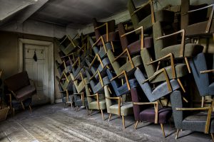 Old chairs stack upon one another