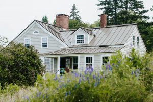 A house surrounded by many trees and bushes