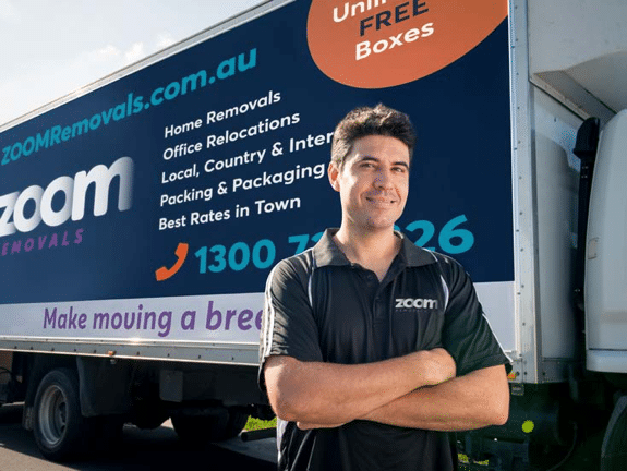 ZOOM Removals Staff Member Next to Moving Truck