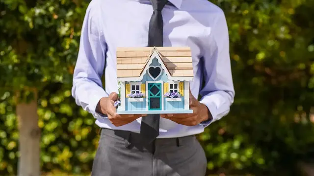 working-man-holding-a-small-house