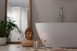 Bathroom Interior With Golden Buddha Sculpture And Modern White