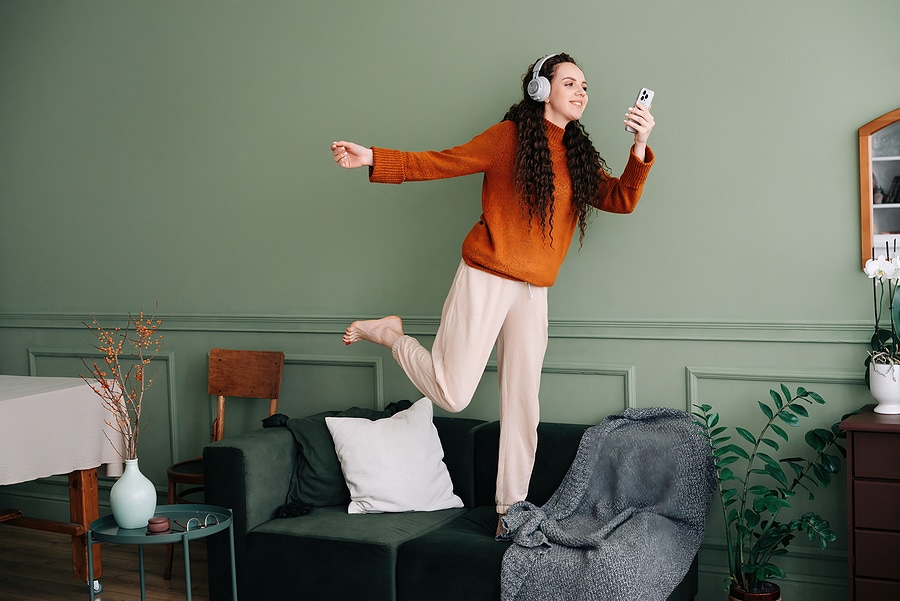 A Young Woman Wearing Headphones Dancing