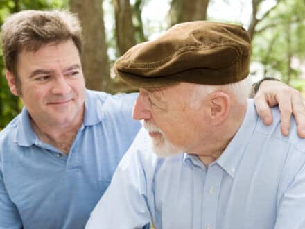 Senior father with his middle aged son. Focus on the elderly man.